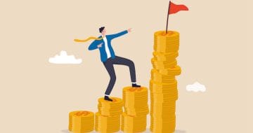 Man climbing up coins